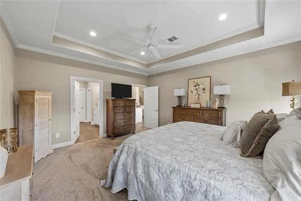 a spacious bedroom with a bed and a chandelier