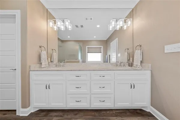 a bathroom with a sink vanity and a mirror