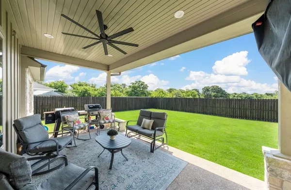 a view of a chairs and table in the patio