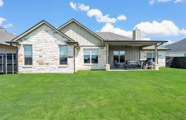 a front view of house with yard and outdoor seating