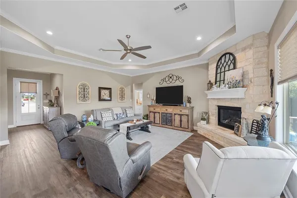 a living room with furniture a fireplace and a flat screen tv