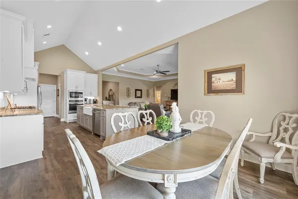 a living room with furniture and kitchen view