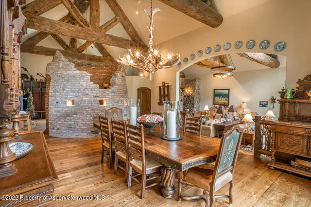 a kitchen with sink a stove and chairs