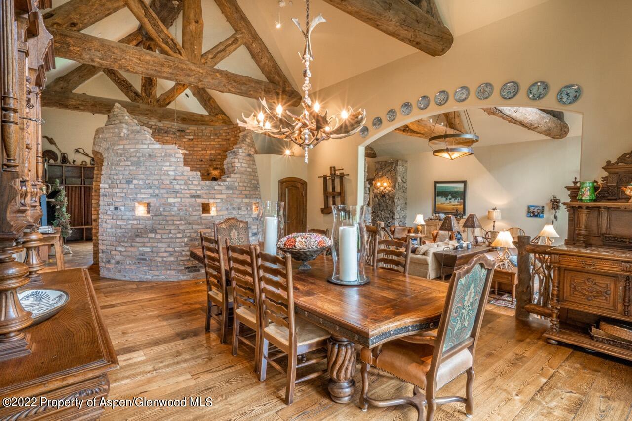 800 South Hayden Road Aspen, CO 81611 - Photo 19 of 60 a view of a dining room with furniture and chandelier