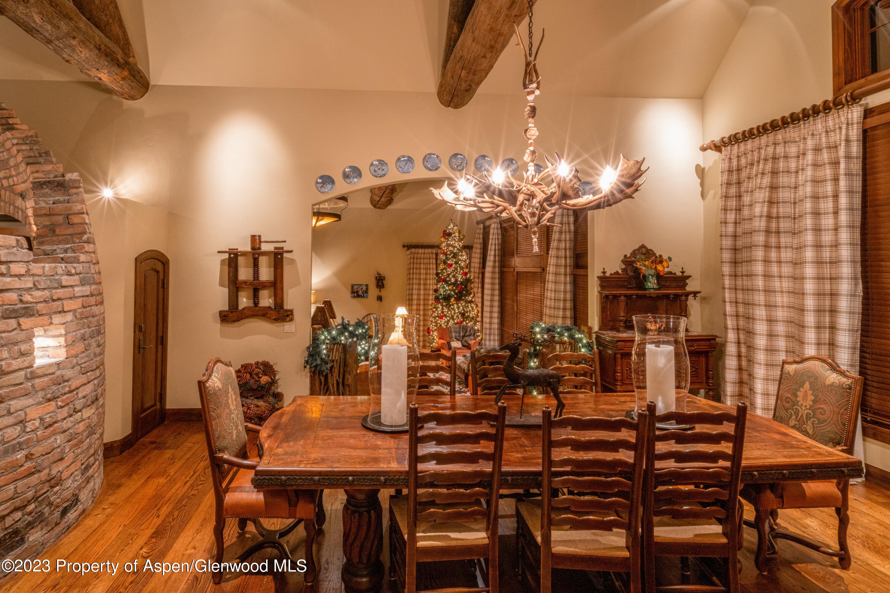 800 South Hayden Road Aspen, CO 81611 - Photo 21 of 60 a view of a dining room with furniture and chandelier