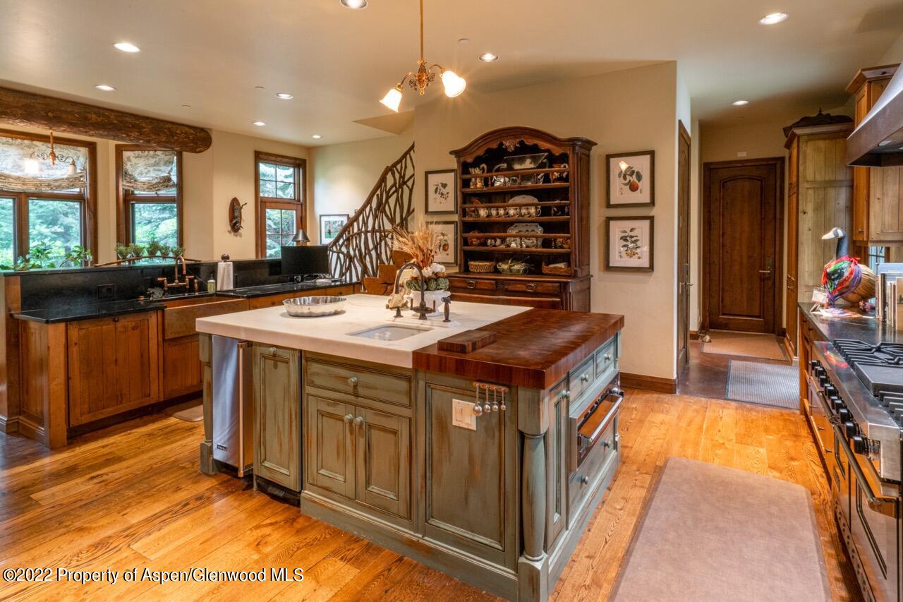 800 South Hayden Road Aspen, CO 81611 - Photo 27 of 60 a kitchen with a sink stove and cabinets
