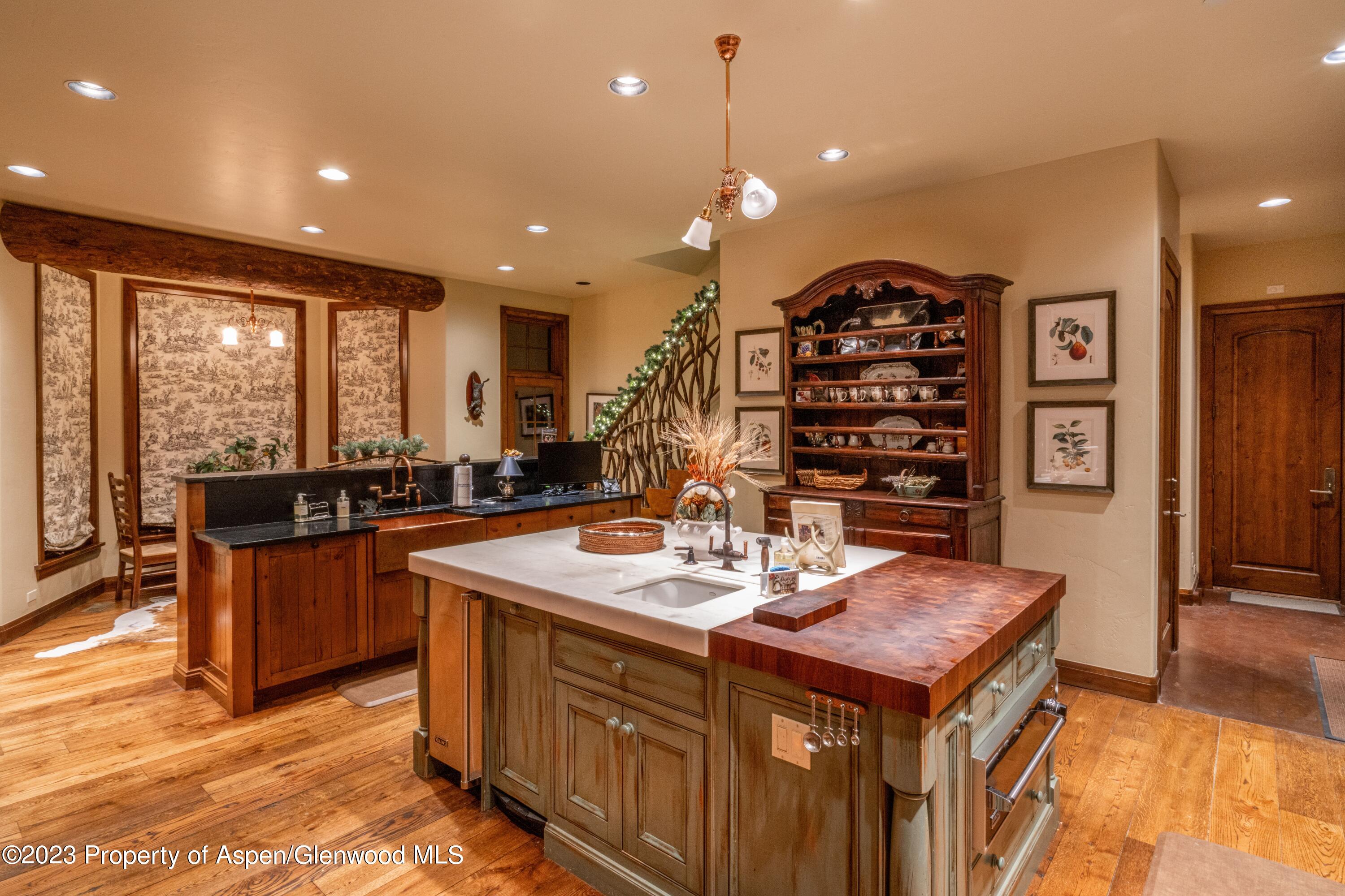 800 South Hayden Road Aspen, CO 81611 - Photo 29 of 60 a kitchen with a counter top space a sink appliances and cabinets
