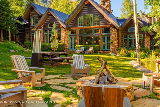 a very nice looking living room with furniture and floor to ceiling windows