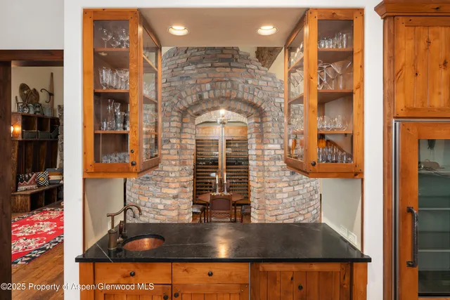 a bathroom with a tub a sink and a large mirror