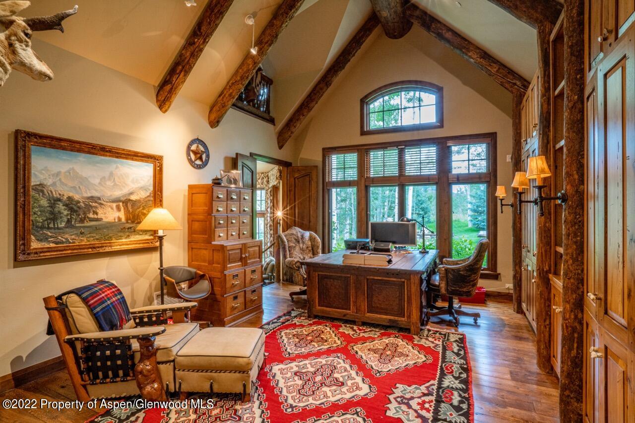 800 South Hayden Road Aspen, CO 81611 - Photo 34 of 60 a living room with furniture a rug and a large window