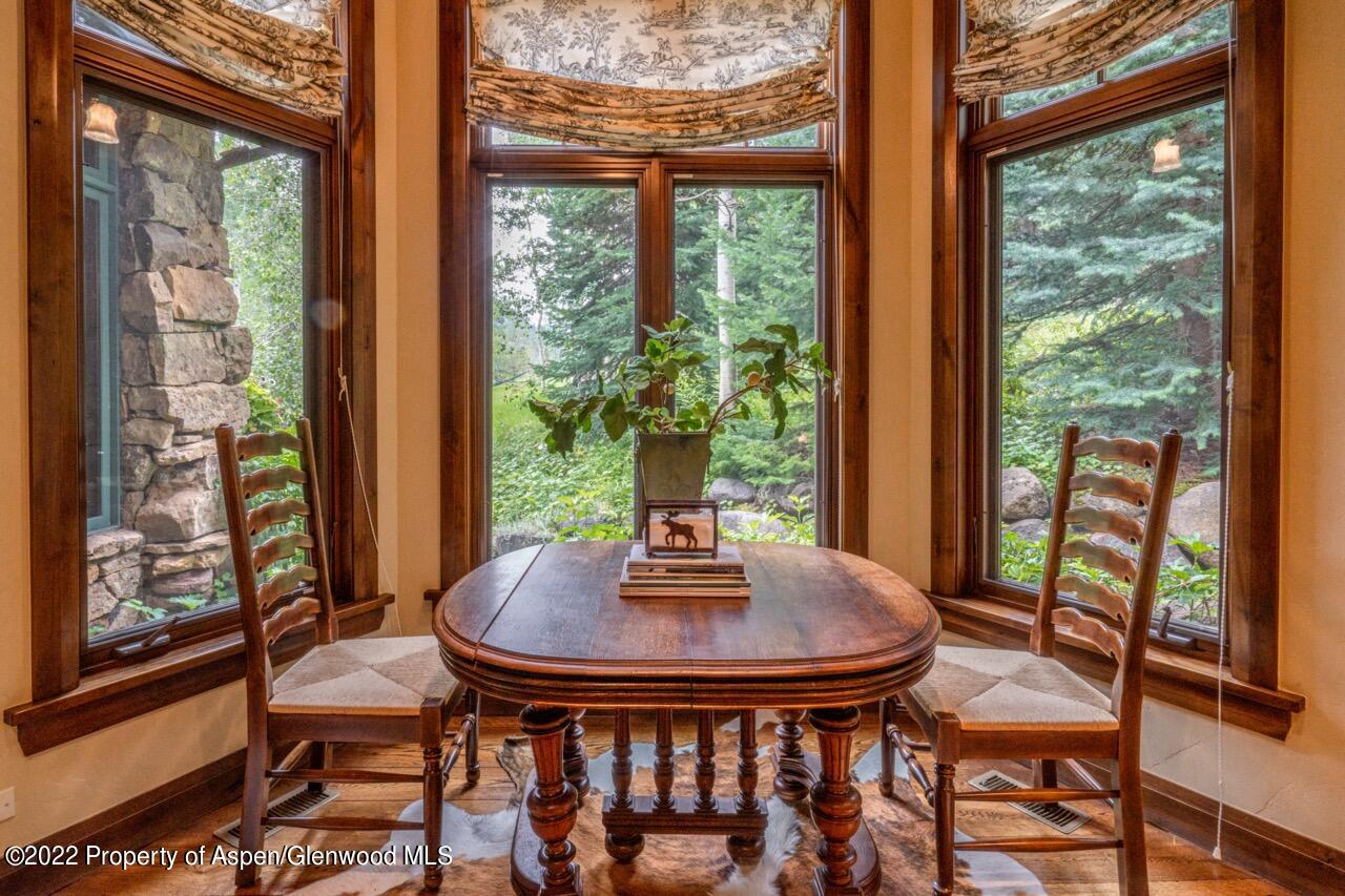 800 South Hayden Road Aspen, CO 81611 - Photo 40 of 60 a view of a dining room with furniture and wooden floor