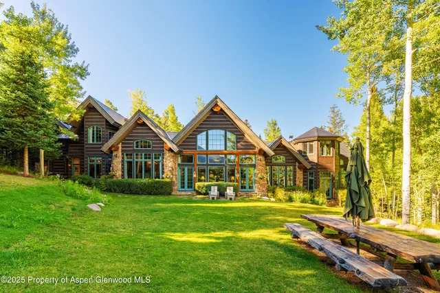 a living room with lots of furniture and a large window