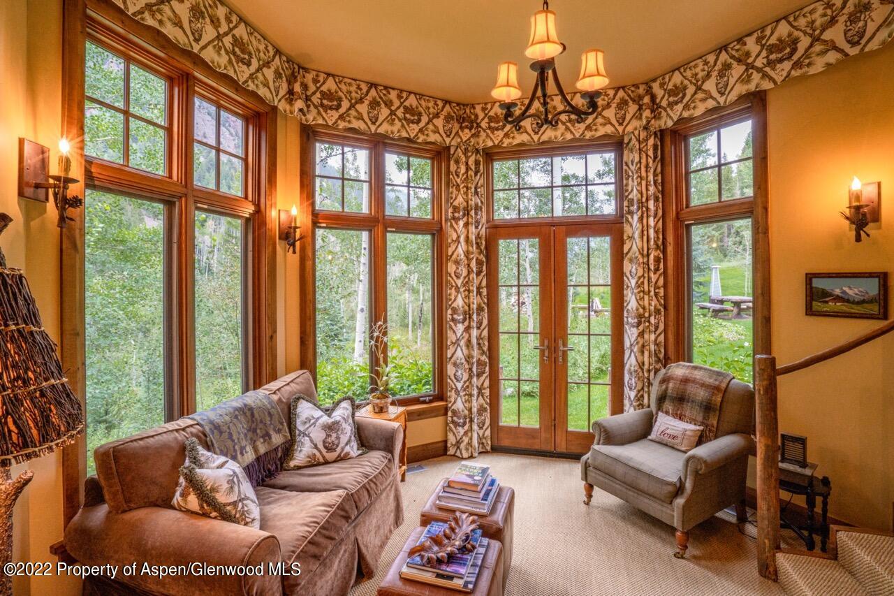 800 South Hayden Road Aspen, CO 81611 - Photo 42 of 60 a living room with furniture and floor to ceiling windows