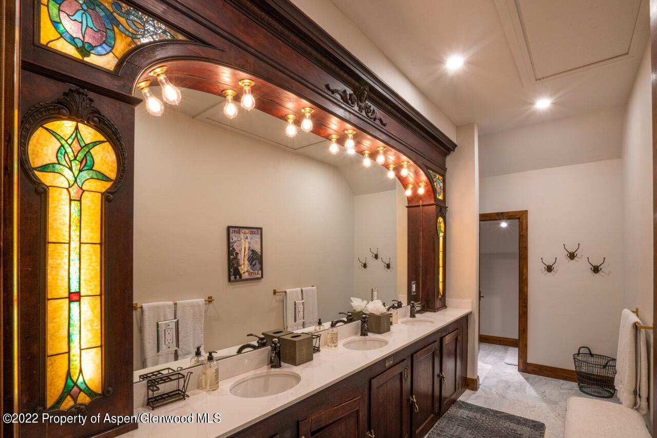 800 South Hayden Road Aspen, CO 81611 - Photo 51 of 60 a bathroom with a double vanity sink and a mirror