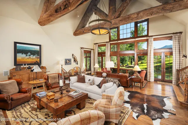 a living room with patio furniture and a window