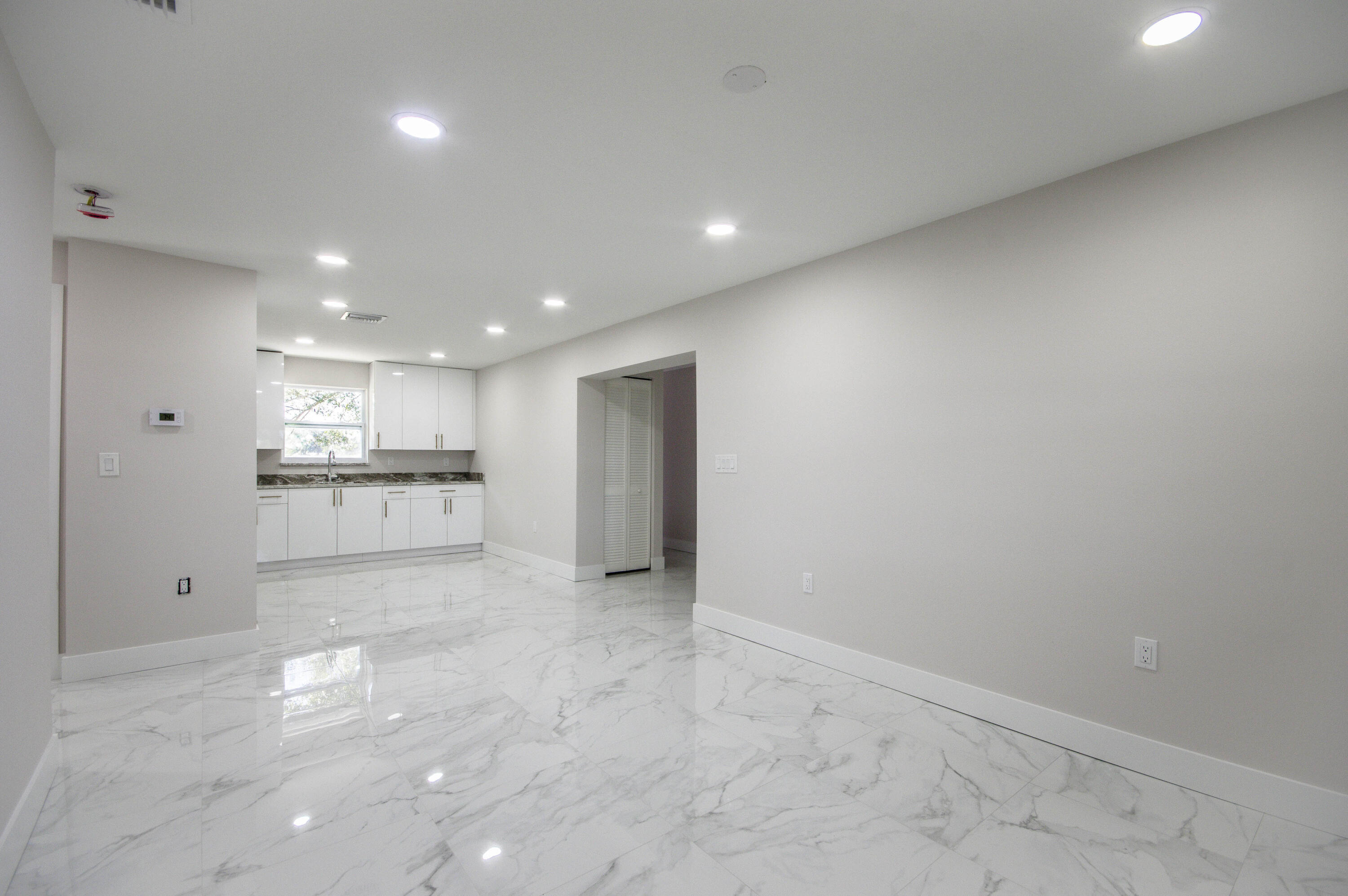 311 Southwest 67th Drive Okeechobee, FL 34974 - Photo 13 of 30 a view of a kitchen with a sink and a refrigerator