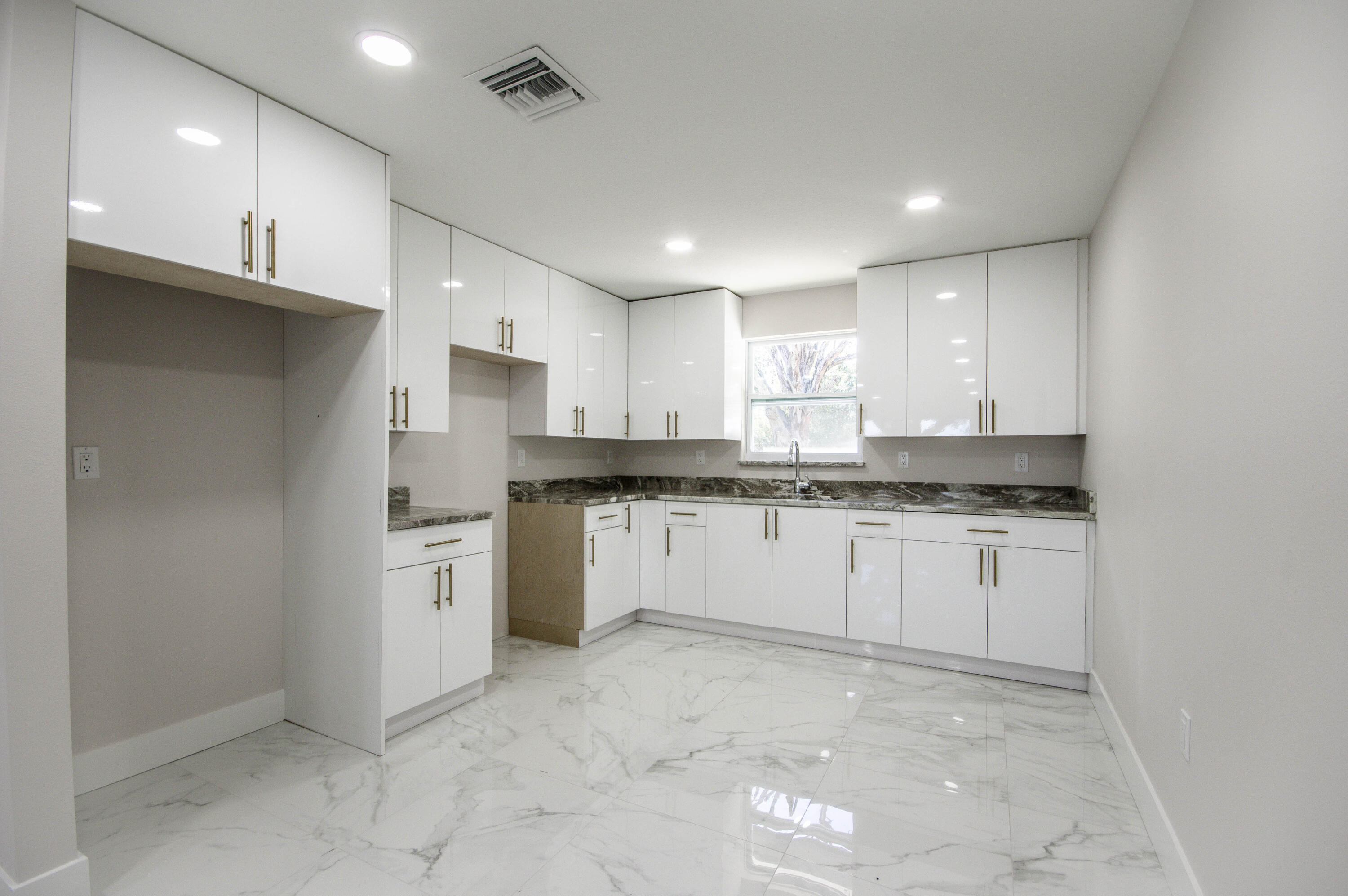 311 Southwest 67th Drive Okeechobee, FL 34974 - Photo 14 of 30 a kitchen with granite countertop white cabinets and white stainless steel appliances