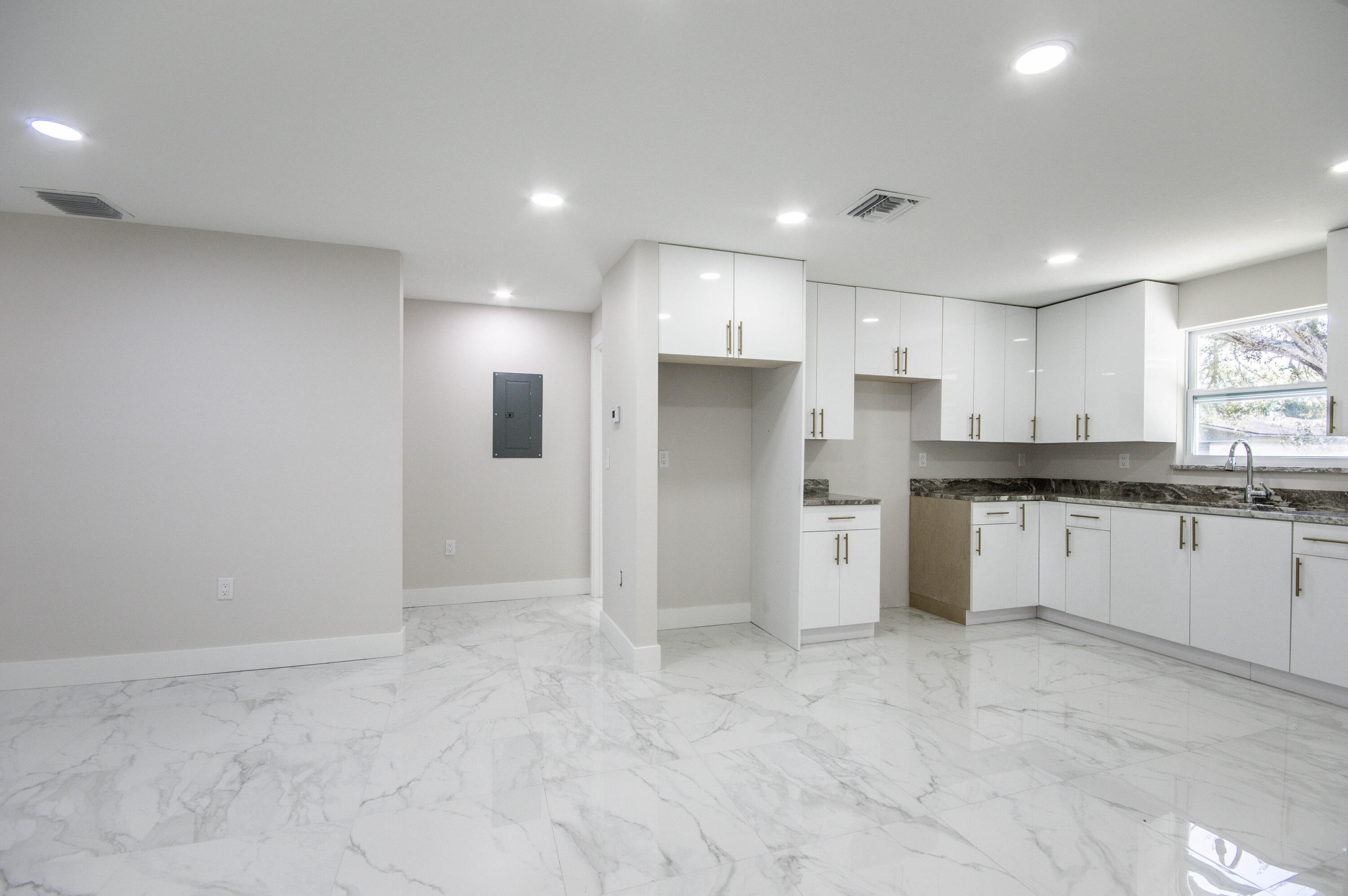 311 Southwest 67th Drive Okeechobee, FL 34974 - Photo 16 of 30 a kitchen with white cabinets and stainless steel appliances