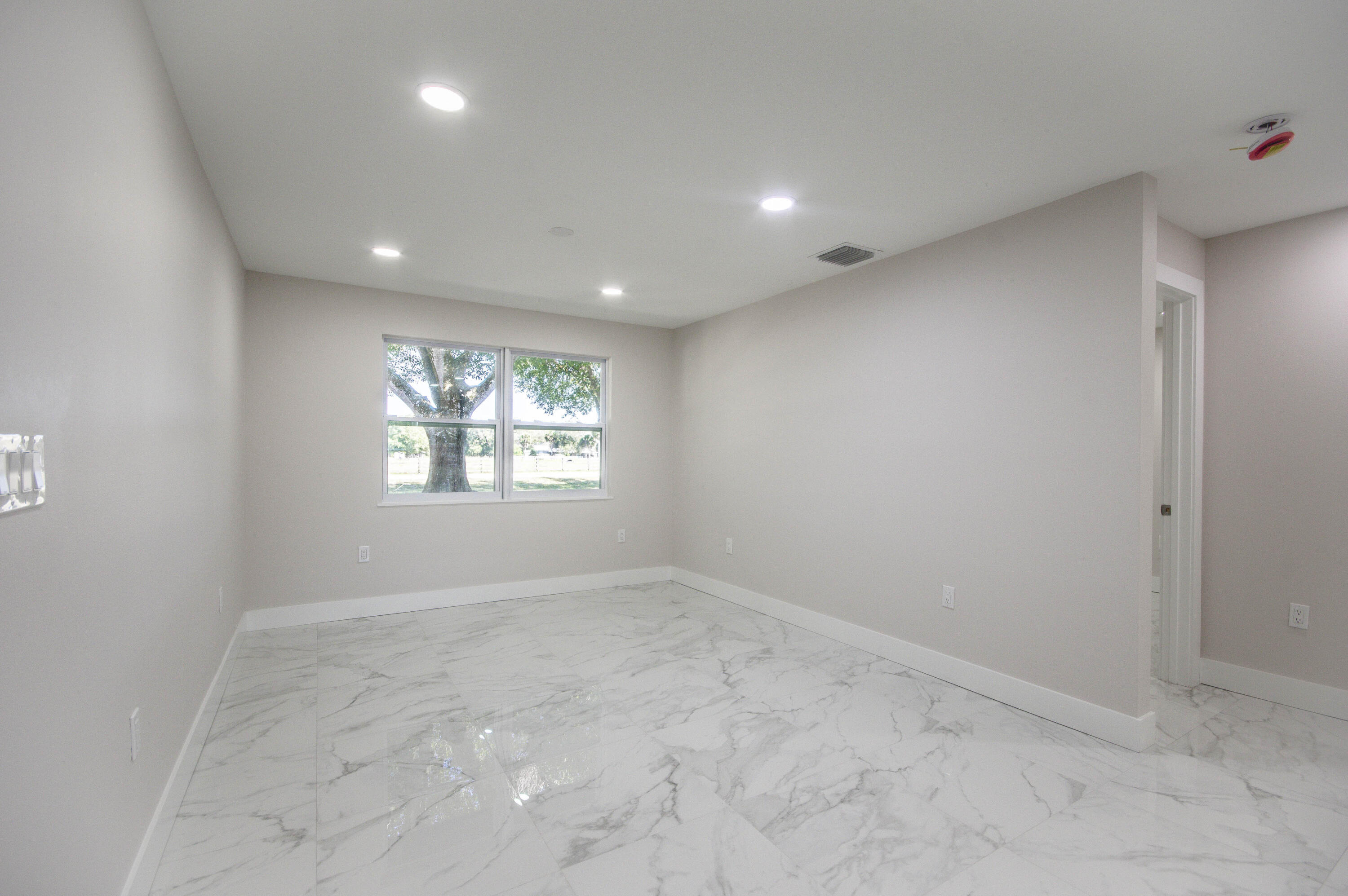 311 Southwest 67th Drive Okeechobee, FL 34974 - Photo 17 of 30 an empty room with windows