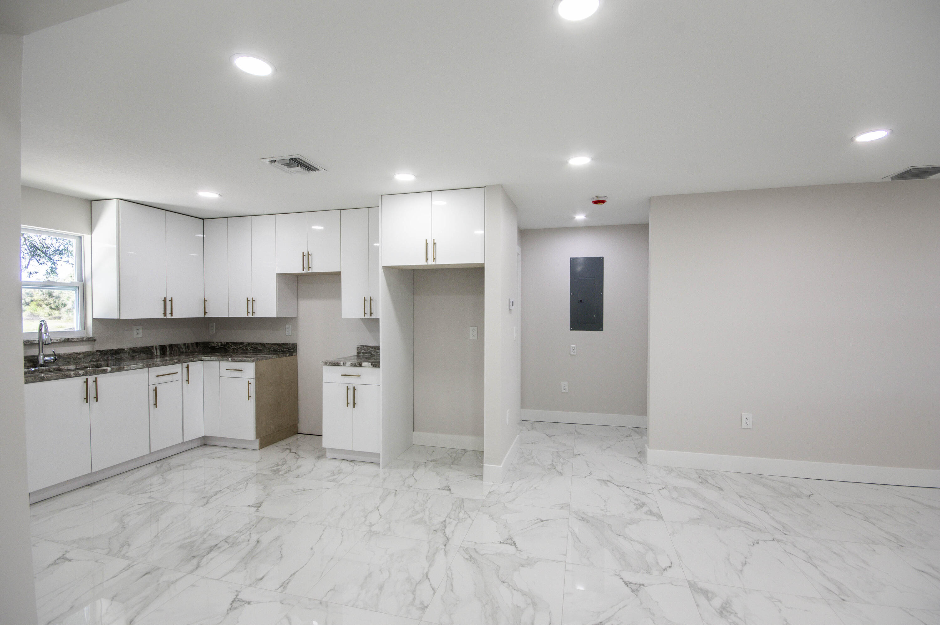311 Southwest 67th Drive Okeechobee, FL 34974 - Photo 5 of 30 a view of a kitchen with refrigerator stove sink and cabinets