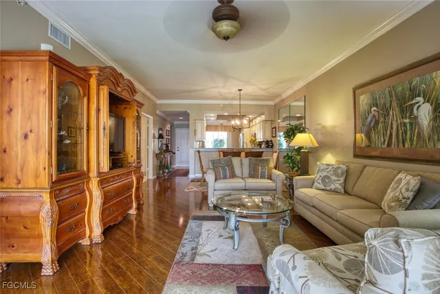 a living room with furniture and a chandelier