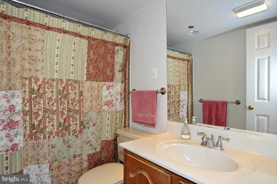 1301 North Courthouse Road, Unit 1507 Arlington, VA 22201 - Photo 12 of 16 a bathroom with a sink and a mirror