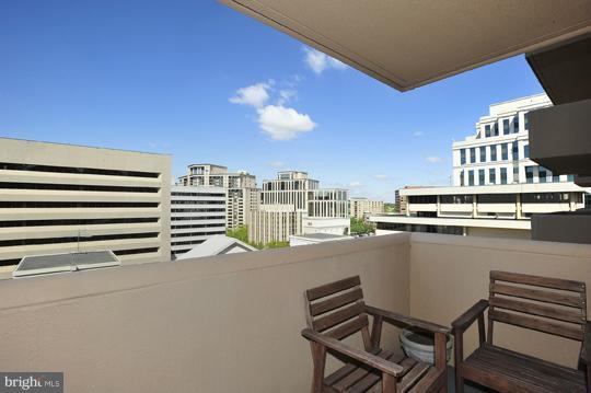 1301 North Courthouse Road, Unit 1507 Arlington, VA 22201 - Photo 3 of 16 a balcony with a water view and a fireplace