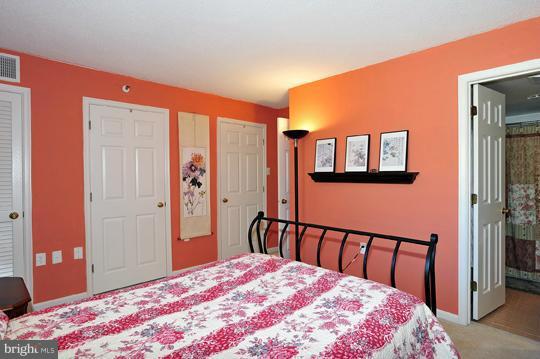 1301 North Courthouse Road, Unit 1507 Arlington, VA 22201 - Photo 5 of 16 a bedroom with a bed and a dresser