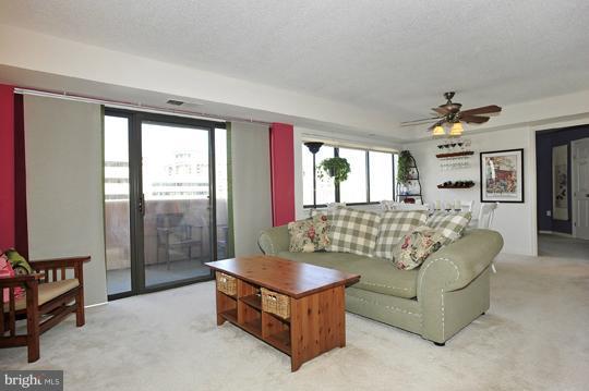 1301 North Courthouse Road, Unit 1507 Arlington, VA 22201 - Photo 7 of 16 a living room with furniture and a large window