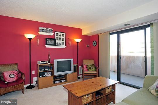 1301 North Courthouse Road, Unit 1507 Arlington, VA 22201 - Photo 8 of 16 a living room with furniture flat screen tv and a fireplace