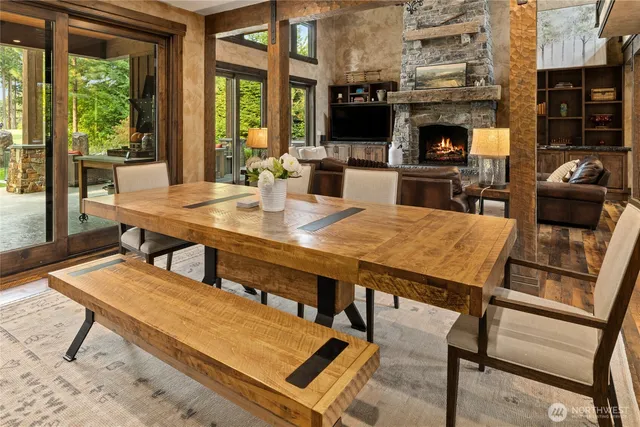 a living room with furniture a fireplace and a floor to ceiling window