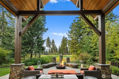 a view of yard from deck with patio