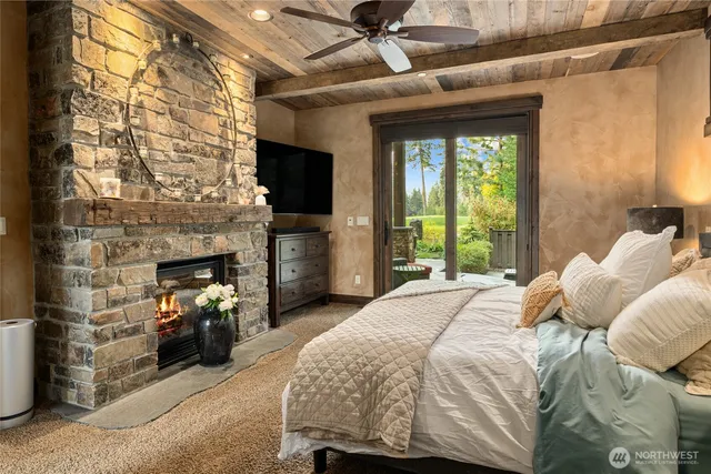 a bedroom with a bed and a fireplace