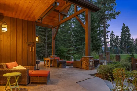 a backyard of a house with fountain table and chairs