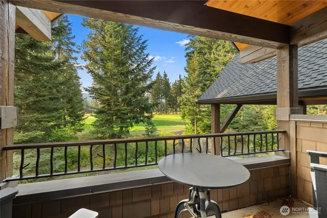 a bedroom with a bed a flat screen tv and a chandelier