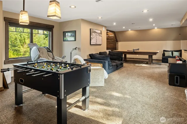 a room with furniture pool table and a large window