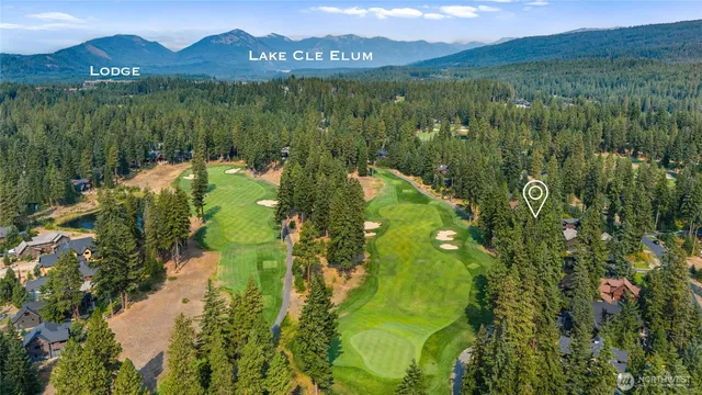 an aerial view of a house with swimming pool and garden