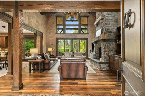 a living room with fireplace furniture and a floor to ceiling window