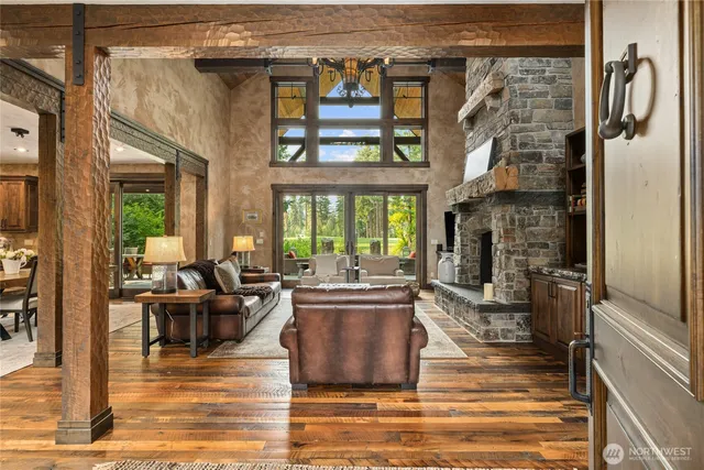 a living room with fireplace furniture and a floor to ceiling window