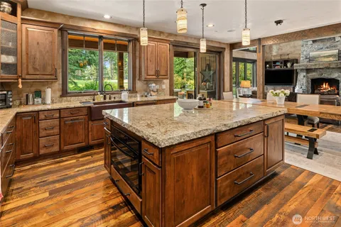 a kitchen with stainless steel appliances granite countertop a sink and a stove