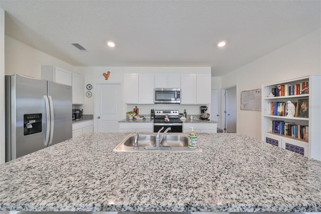 3528 Maple Grv Way Plant City, FL 33565 - Photo 16 of 51 a kitchen with stainless steel appliances granite countertop a refrigerator sink and cabinets