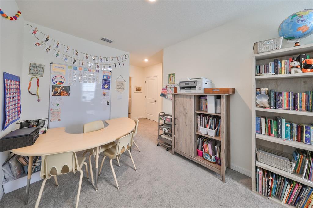 3528 Maple Grv Way Plant City, FL 33565 - Photo 19 of 51 a view of a dining room with furniture and a book shelf
