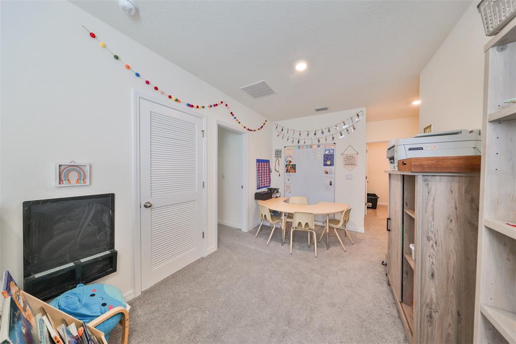 3528 Maple Grv Way Plant City, FL 33565 - Photo 20 of 51 a dining room with furniture and a flat screen tv