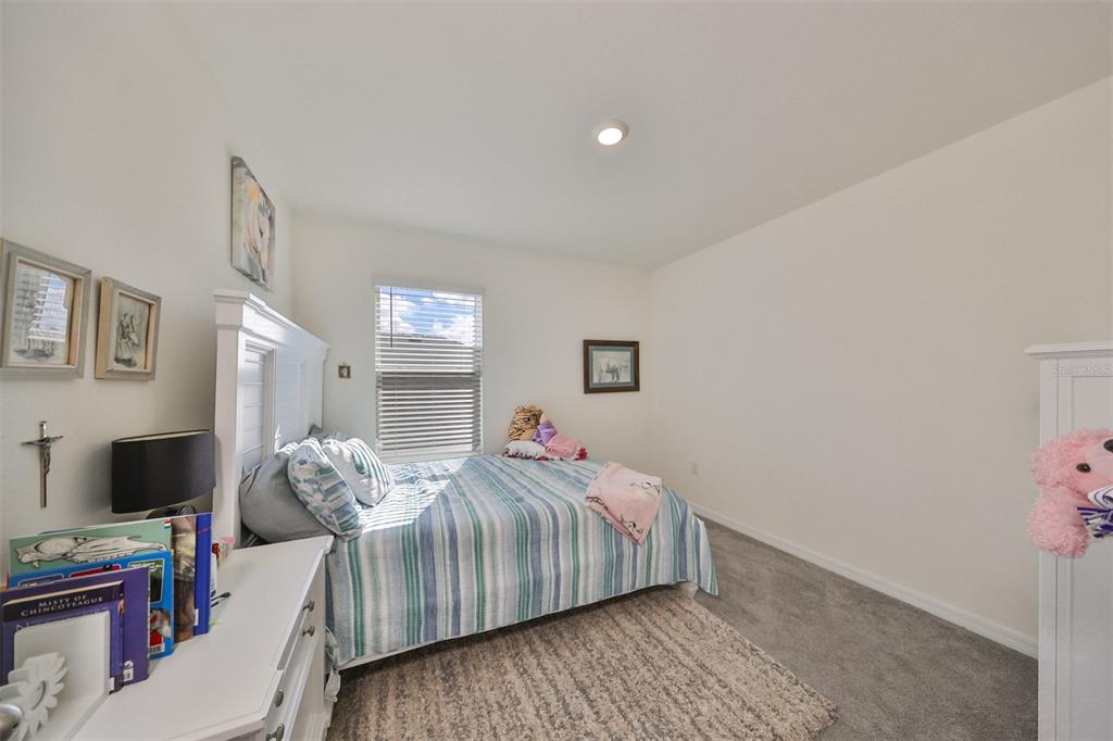 3528 Maple Grv Way Plant City, FL 33565 - Photo 34 of 51 a bedroom with a bed and a flat screen tv