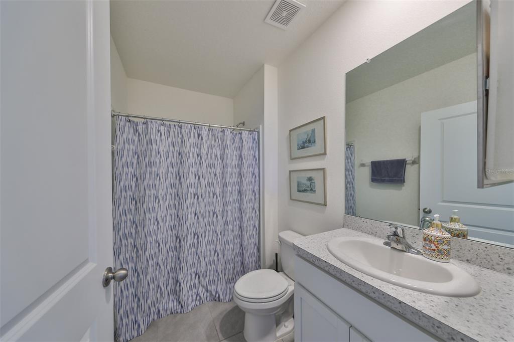 3528 Maple Grv Way Plant City, FL 33565 - Photo 39 of 51 a bathroom with a granite countertop toilet a sink and a mirror