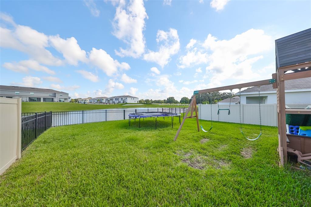 3528 Maple Grv Way Plant City, FL 33565 - Photo 43 of 51 a view of a backyard with grass and a large tree