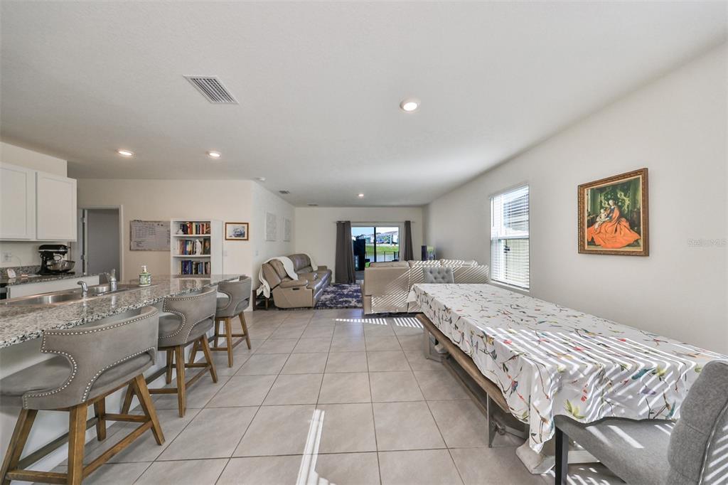 3528 Maple Grv Way Plant City, FL 33565 - Photo 7 of 51 a spacious bedroom with a bed a table and chairs in it