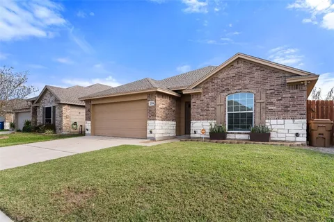 a living room with furniture a flat screen tv and kitchen view