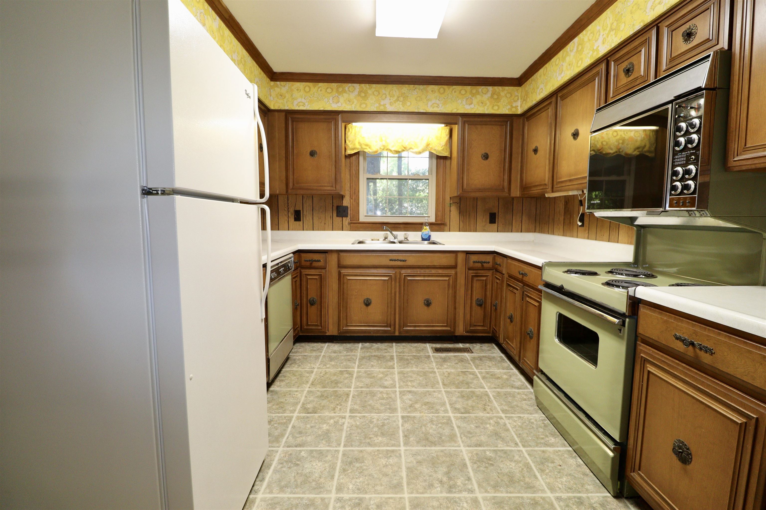 274 Church Street Ripley, TN 38063 - Photo 6 of 30 a kitchen with a sink cabinets stainless steel appliances and a window