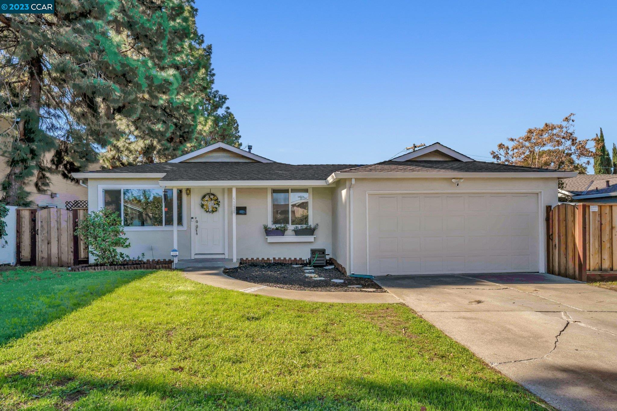 a front view of a house with a garden and yard